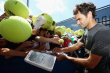 Federer signs autographs after practice Thursday at the U.S. Open (Photo by Mike Stobe/Getty Images for USTA)