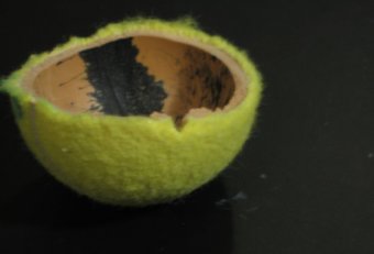 Cut tennis ball in half