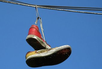 Pair of tennis shoes hanging
