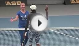 Three dogs are ball boys in a Venus Williams tennis match